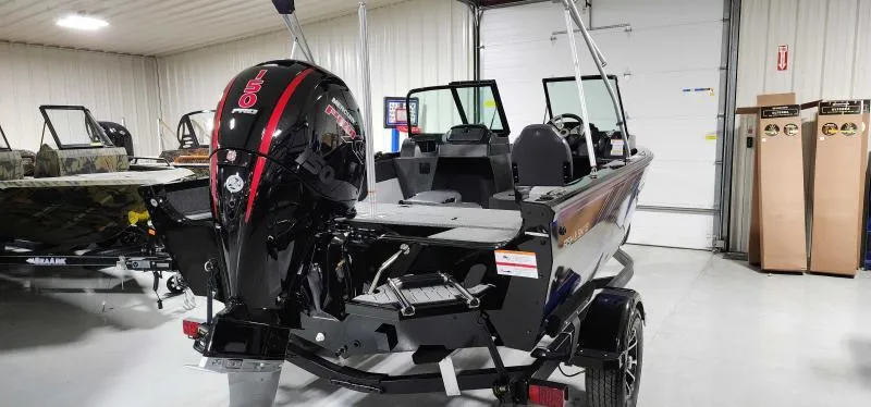 Slide: The Image of 2023 Lowe Fish & Ski 18 boat in showroom, rear view with outboard motor. - 10