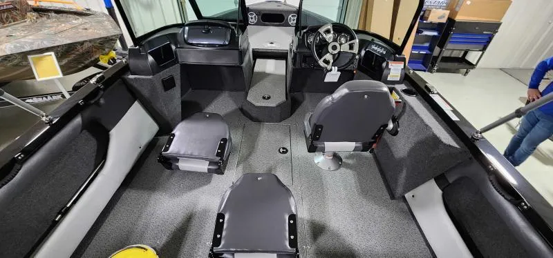 Slide: The Image of 2023 Lowe Fish & Ski 18 interior with seating and steering console. - 4