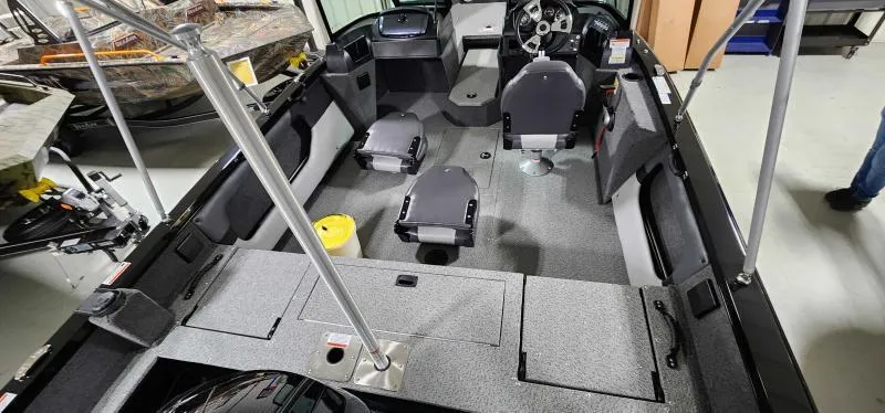 Slide: The Image of 2023 Lowe Fish & Ski 18 boat interior with seating and storage compartments. - 5