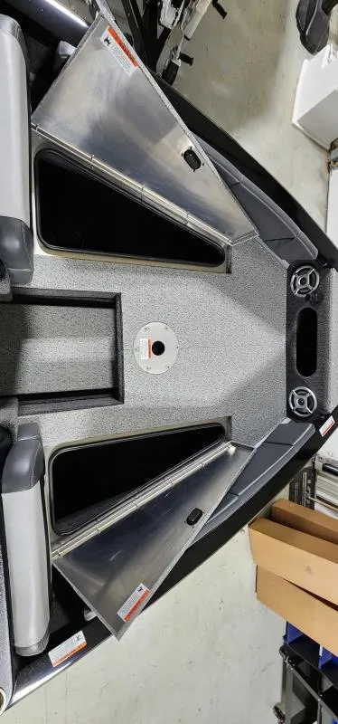 Slide: The Image of 2023 Lowe Fish & Ski 18 boat interior with open storage compartments. - 6