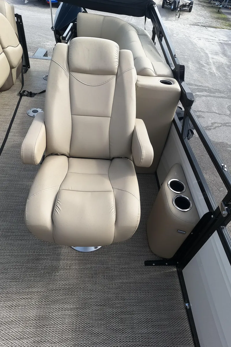 Slide: The Image of Luxurious beige captain's chair on a 2023 Regency 230 DL3 pontoon boat. - 13