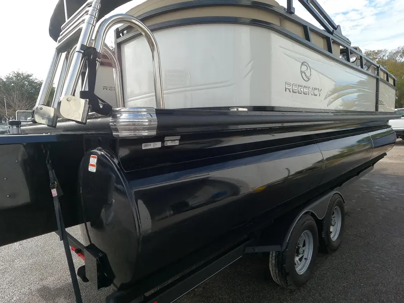 Slide: The Image of 2023 Regency 230 DL3 pontoon boat on a trailer. - 2