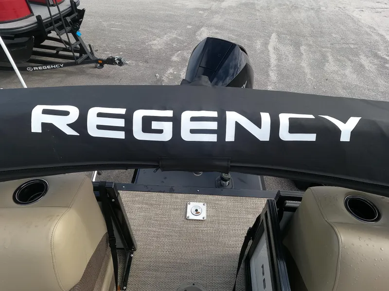Slide: The Image of 2023 Regency 230 DL3 boat interior with logo and seating. - 5