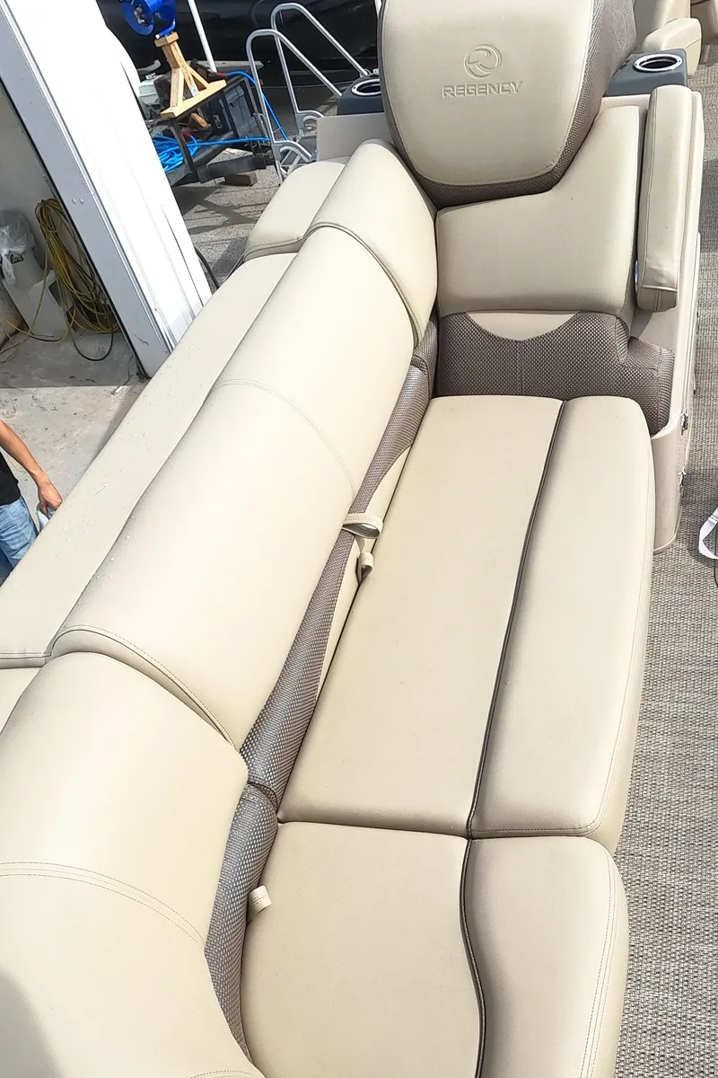 Slide: The Image of 2023 Regency 230 DL3 boat interior with beige leather seating. - 7