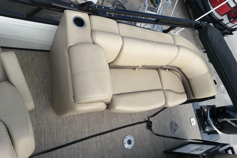 Slide: The Image of 2023 Regency 230 DL3 boat with beige leather seating and cup holders. - 8