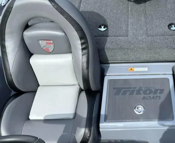 Slide: The Image of 2024 Triton 179 TrX boat interior with branded seat and storage compartment. - 6