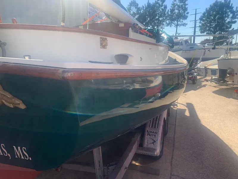 Slide: The Image of 1977 Marshall 22 sailboat on trailer, green hull, outdoor setting. - 15