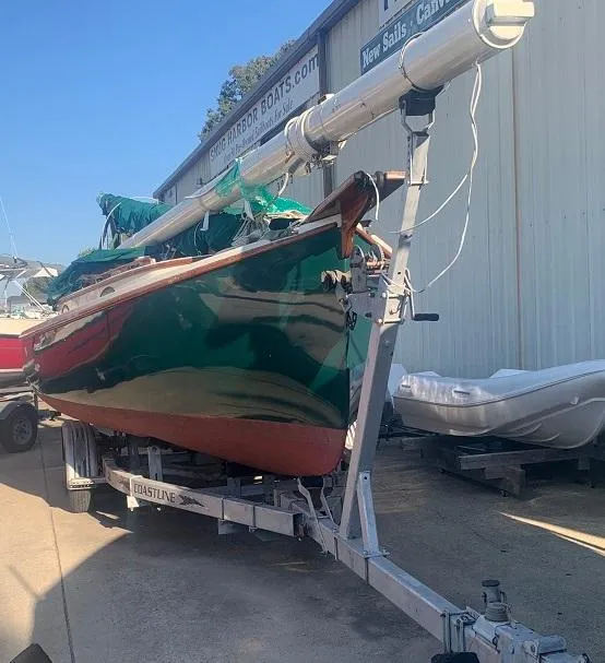 Slide: The Image of 1977 Marshall 22 sailboat on trailer, green hull, docked at a marina. - 16