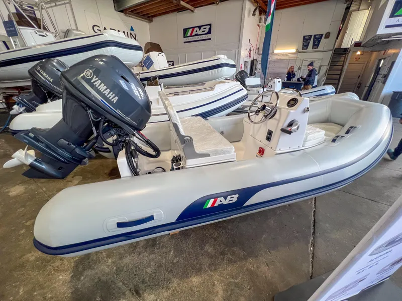 Slide: The Image of 2023 AB Inflatables Nautilus 13 DLX with Yamaha outboard motor in showroom. - 2