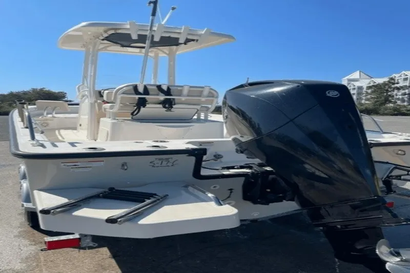 Slide: The Image of 2021 Boston Whaler 210 Montauk boat with outboard motor and T-top, parked on trailer. - 15