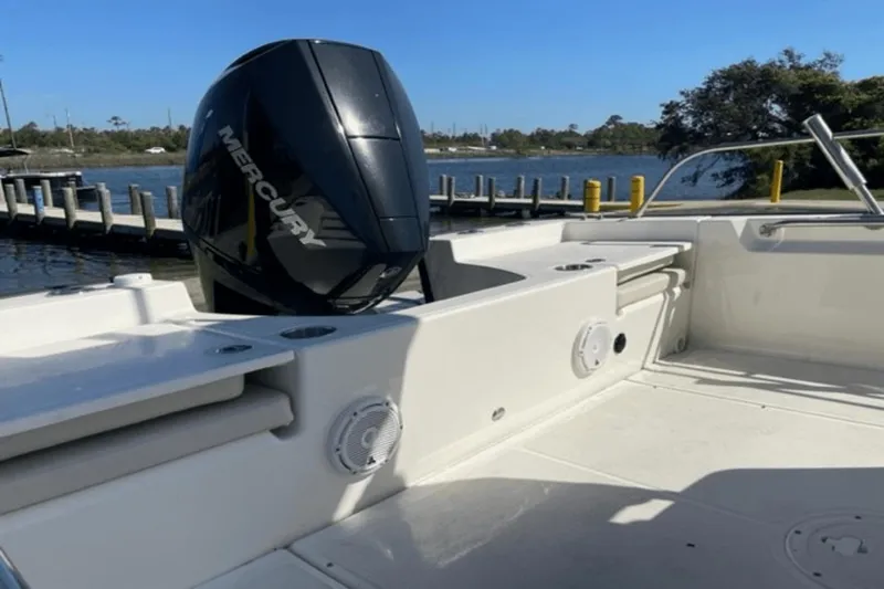 Slide: The Image of 2021 Boston Whaler 210 Montauk boat with Mercury engine, docked by a scenic waterfront. - 16