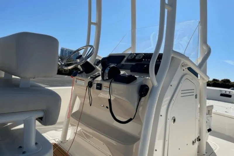 Slide: The Image of 2021 Boston Whaler 210 Montauk boat console with steering wheel and controls. - 18