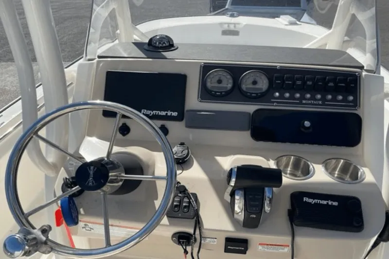 Slide: The Image of 2021 Boston Whaler 210 Montauk dashboard with steering wheel and Raymarine electronics. - 20