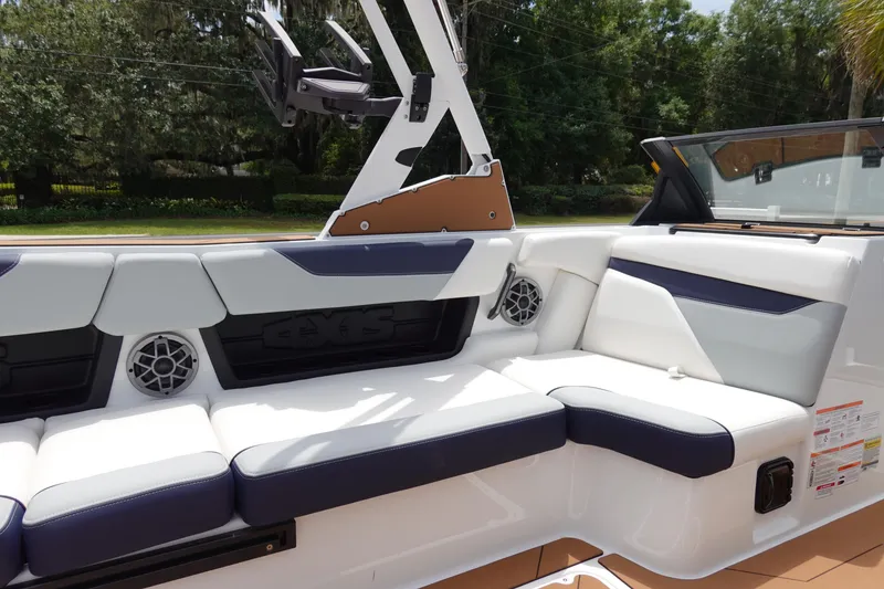 Slide: The Image of 2023 Axis A24 boat interior with white and navy seating, speakers, and sleek design. - 15