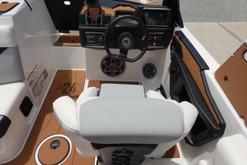 Slide: The Image of 2023 Axis A24 boat interior with steering wheel and dashboard controls. - 20