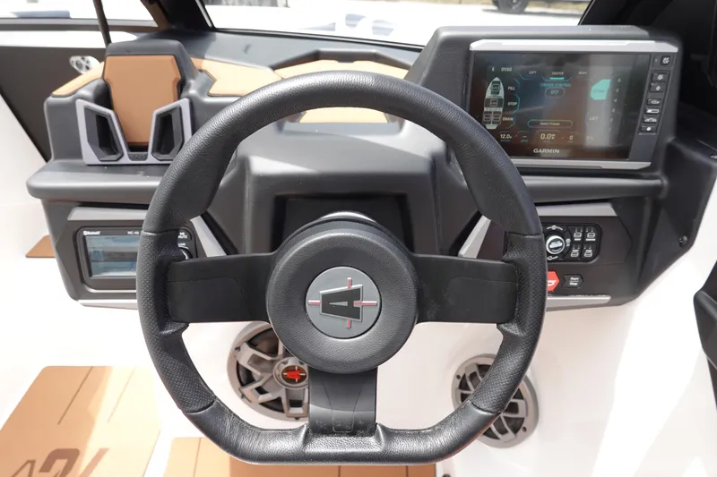Slide: The Image of 2023 Axis A24 boat dashboard with steering wheel and digital display. - 21