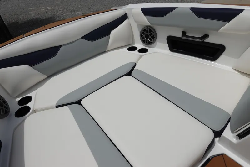 Slide: The Image of 2023 Axis A24 boat interior with cushioned seating and built-in speakers. - 26