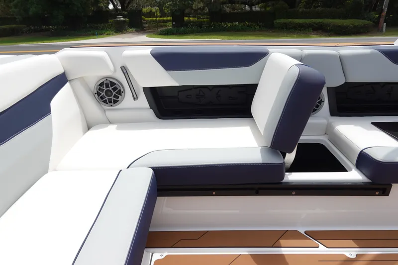 Slide: The Image of 2023 Axis A24 boat interior with white and navy seating, featuring built-in speakers. - 27