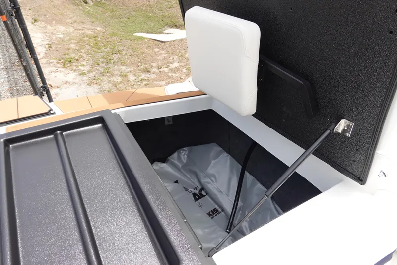 Slide: The Image of Open storage compartment in 2023 Axis A24 boat, featuring cushioned lid and hydraulic support. - 30
