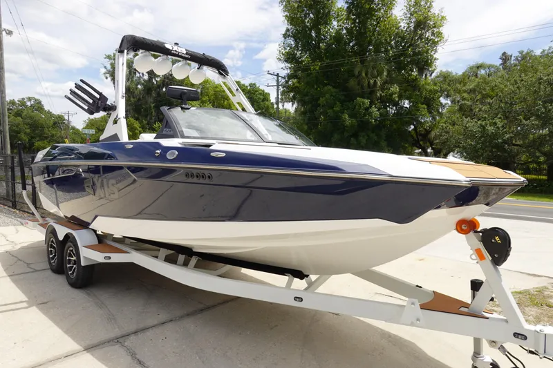 Slide: The Image of 2023 Axis A24 boat on trailer, sleek design, parked outdoors. - 4
