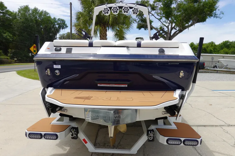 Slide: The Image of 2023 Axis A24 boat rear view with swim platform and speakers. - 7