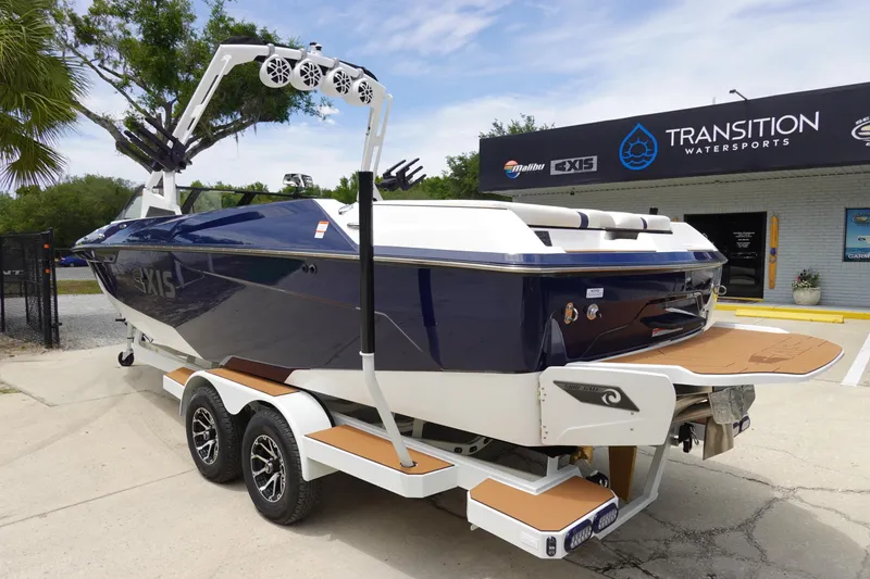Slide: The Image of 2023 Axis A24 boat on trailer at Transition Watersports dealership. - 8