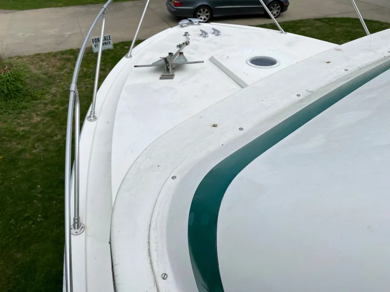 Slide: The Image of 1975 Bertram 28 Flybridge boat deck with anchor, for sale sign in background. - 13