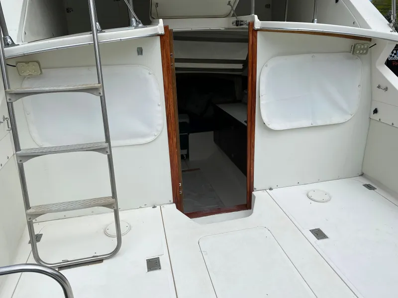Slide: The Image of 1975 Bertram 28 Flybridge boat interior with ladder and open cabin door. - 15