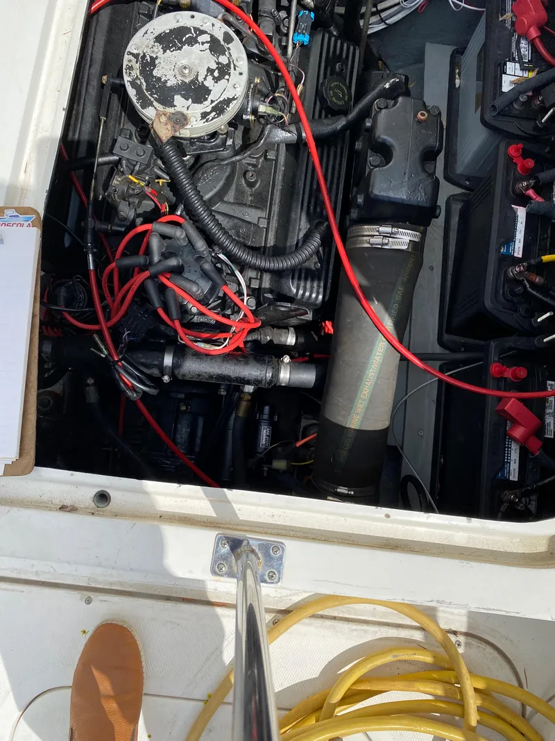 Slide: The Image of 1975 Bertram 28 Flybridge engine compartment with wiring and batteries. - 18