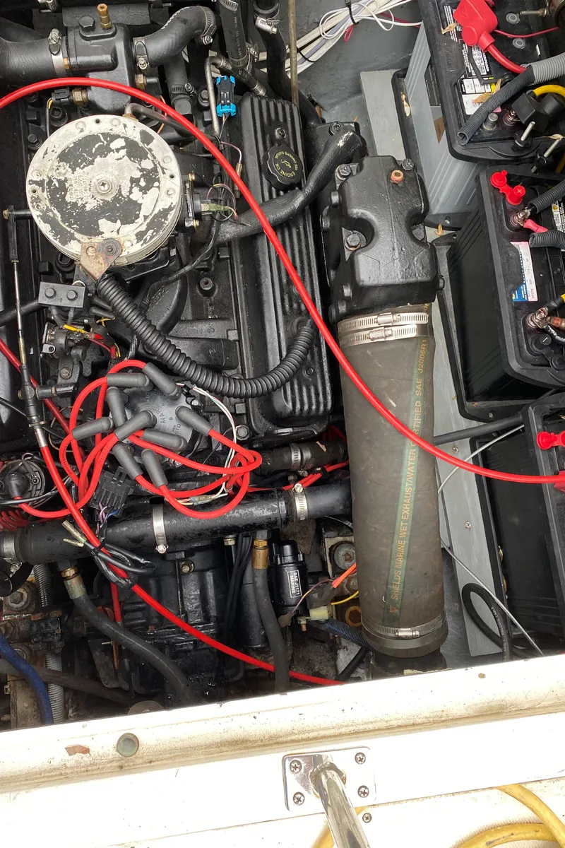 Slide: The Image of 1975 Bertram 28 Flybridge engine compartment with visible wiring and components. - 25