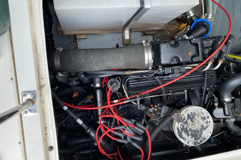 Slide: The Image of 1975 Bertram 28 Flybridge engine compartment with visible wiring and components. - 29