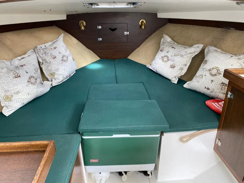 Slide: The Image of 1975 Bertram 28 Flybridge cabin interior with green cushions and decorative pillows. - 3