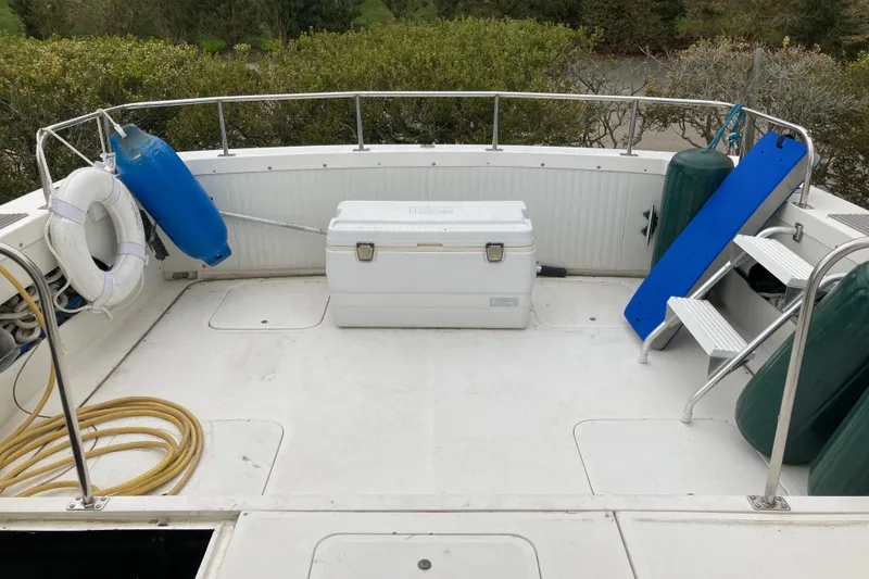 Slide: The Image of 1975 Bertram 28 Flybridge boat deck with cooler, life preserver, and fenders. - 35