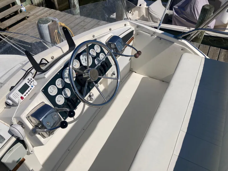 Slide: The Image of 1975 Bertram 28 Flybridge helm with classic steering wheel and instrument panel. - 42
