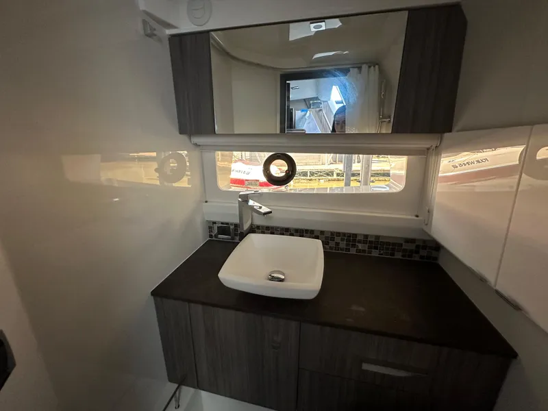 Slide: The Image of Modern bathroom interior of 2023 Sea Ray SLX 400 OB boat with sink and mirror. - 19