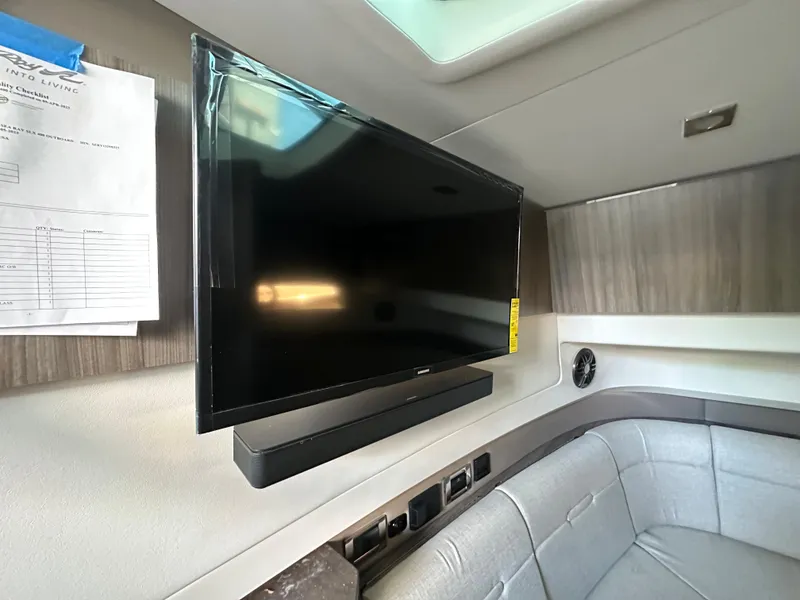 Slide: The Image of Flat-screen TV in the cabin of a 2023 Sea Ray SLX 400 OB boat. - 27