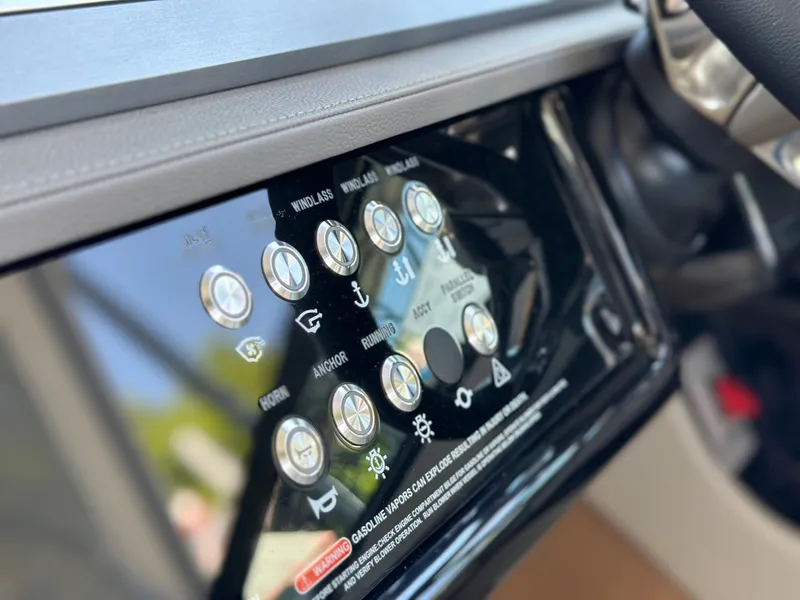 Slide: The Image of Control panel of 2023 Sea Ray SLX 400 OB boat with various function buttons. - 32