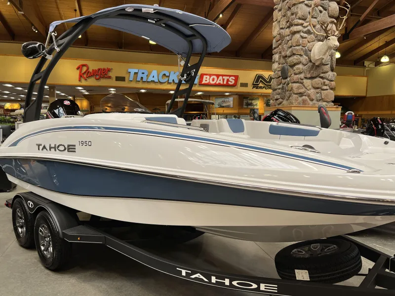The Image of 2023 Tahoe 1950 boat on display in showroom with trailer. - 0