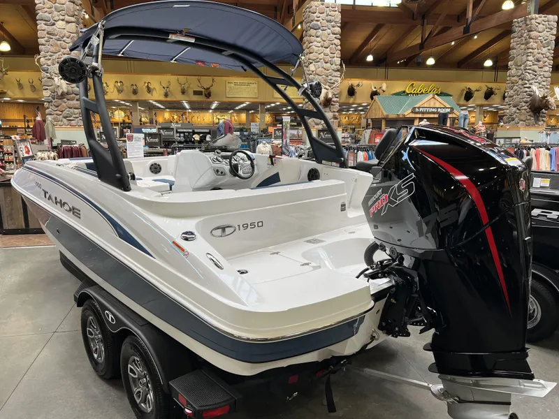 Slide: The Image of 2023 Tahoe 1950 boat with powerful outboard motor on display indoors. - 4