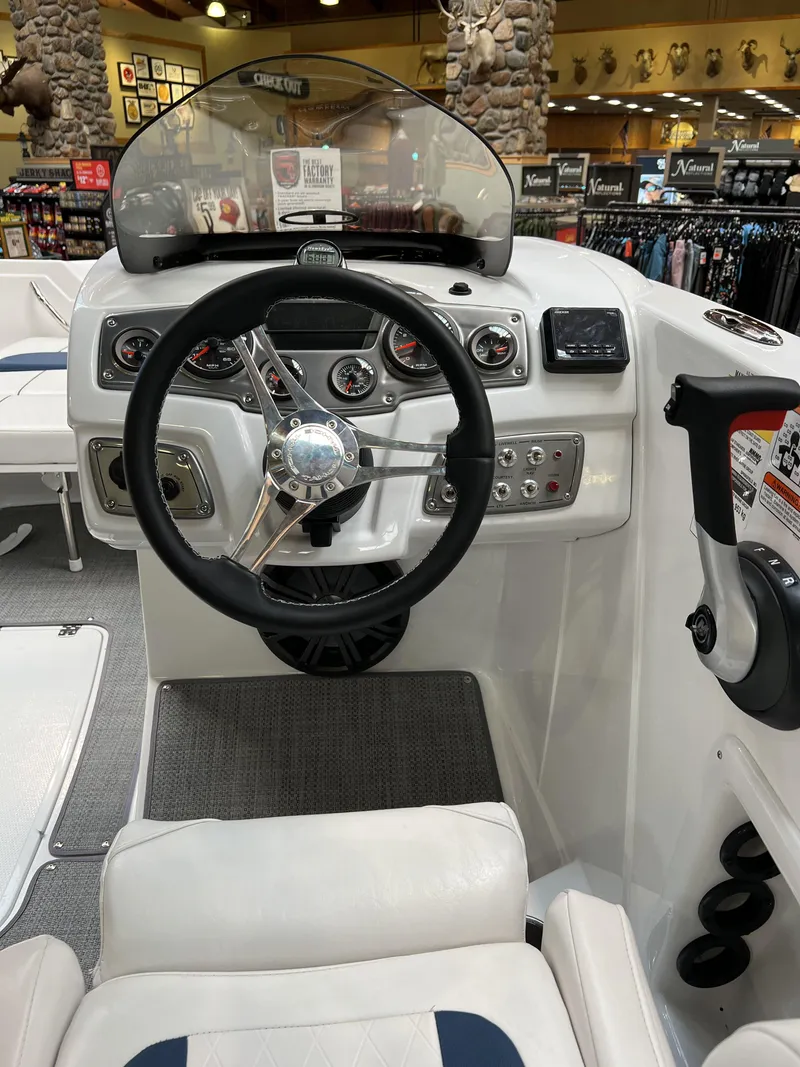 Slide: The Image of Steering console of a 2023 Tahoe 1950 boat with modern controls and gauges. - 5