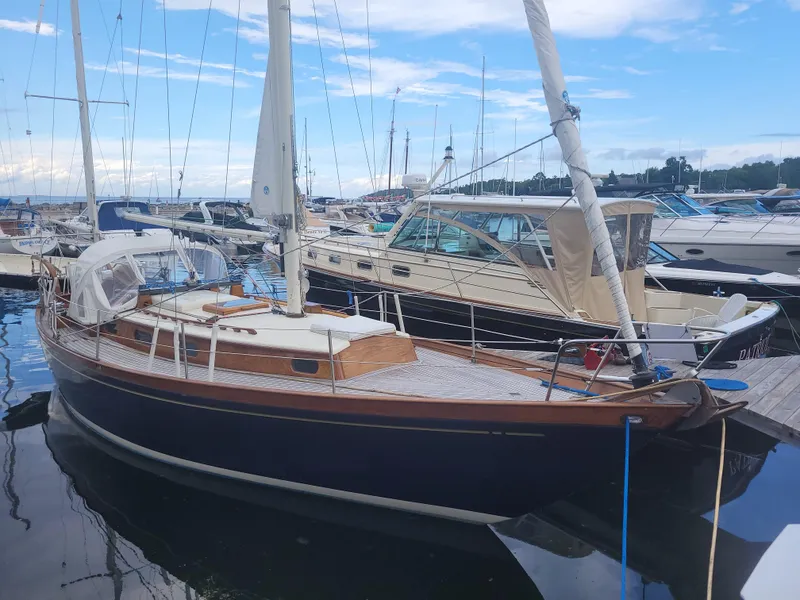 The Image of 1969 Allied Seabreeze 35 sailboat docked at a marina under a blue sky. - 0