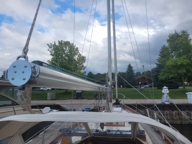 Slide: The Image of 1969 Allied Seabreeze 35 sailboat docked, showcasing mast and rigging under cloudy sky. - 11