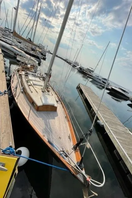 Slide: The Image of 1969 Allied Seabreeze 35 sailboat docked at a marina on a calm day. - 12