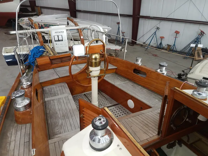 Slide: The Image of 1969 Allied Seabreeze 35 sailboat cockpit with wooden finish and steering wheel. - 20