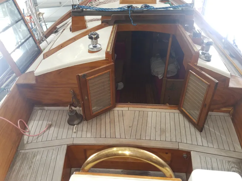 Slide: The Image of 1969 Allied Seabreeze 35 sailboat interior with open wooden cabin doors. - 24