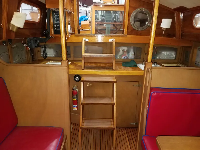 Slide: The Image of Interior of 1969 Allied Seabreeze 35 sailboat with wooden cabinetry and red seating. - 27