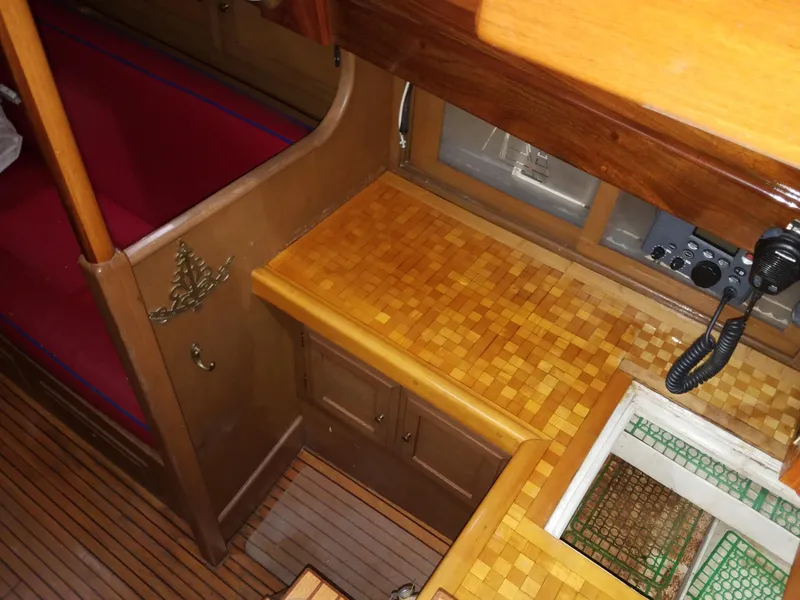 Slide: The Image of Interior of 1969 Allied Seabreeze 35 sailboat with wooden cabinetry and red seating. - 30