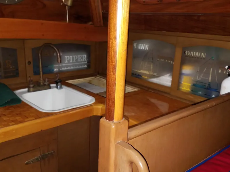 Slide: The Image of Interior of 1969 Allied Seabreeze 35 sailboat with wooden cabinetry and sink. - 32
