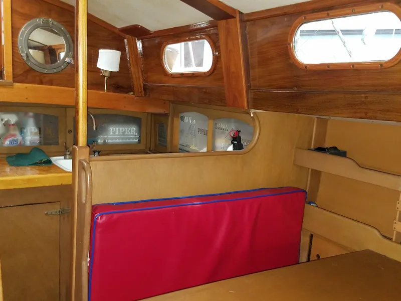 Slide: The Image of Interior of a 1969 Allied Seabreeze 35 sailboat with wooden finishes and red cushion. - 34