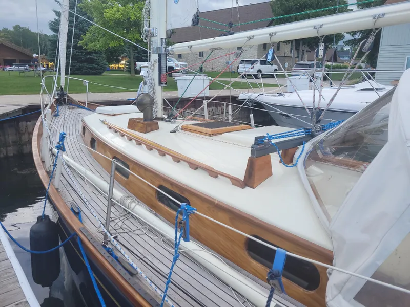 Slide: The Image of 1969 Allied Seabreeze 35 sailboat docked, showcasing wooden deck and rigging details. - 4